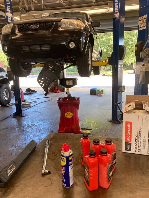 Ford Escape on lift w/ splash guard removed